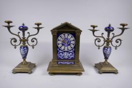 A C19th French bronze and enamelled porcelain clock garniture, the hand painted dial  with mask