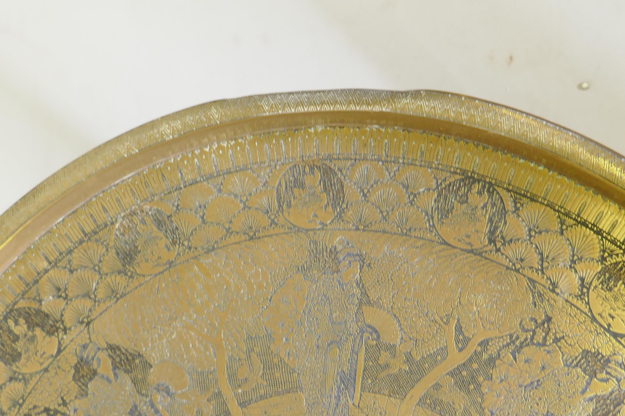 A Victorian brass top table with Japanese inspired decoration, on a folding wood base, 59 dia. x - Image 6 of 7