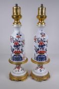 A pair of ormolu and porcelain lamp bases with Imari style decoration, 59cm high
