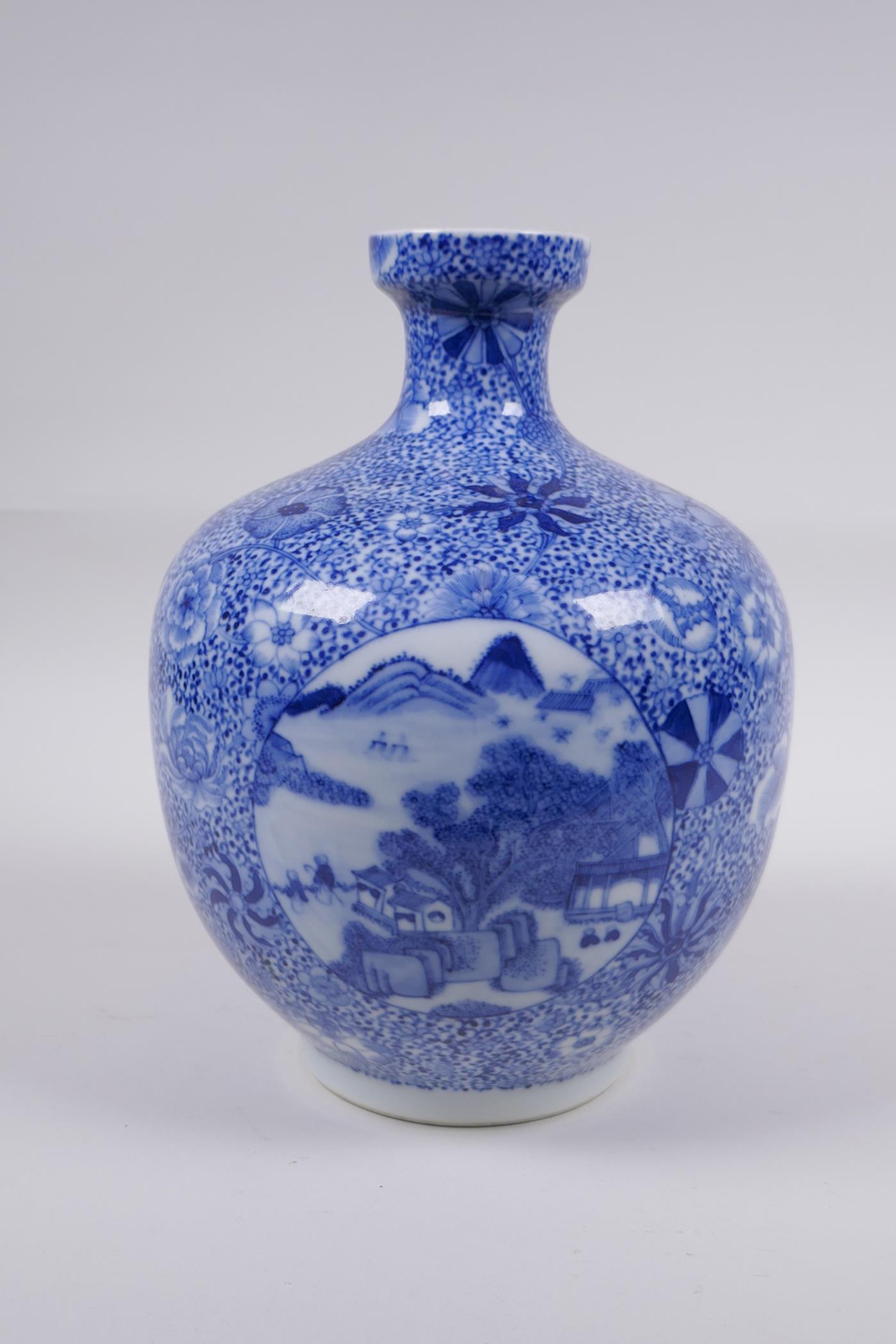 A blue and white porcelain vase with decorative panels depicting landscape scenes, in decorative - Image 2 of 6