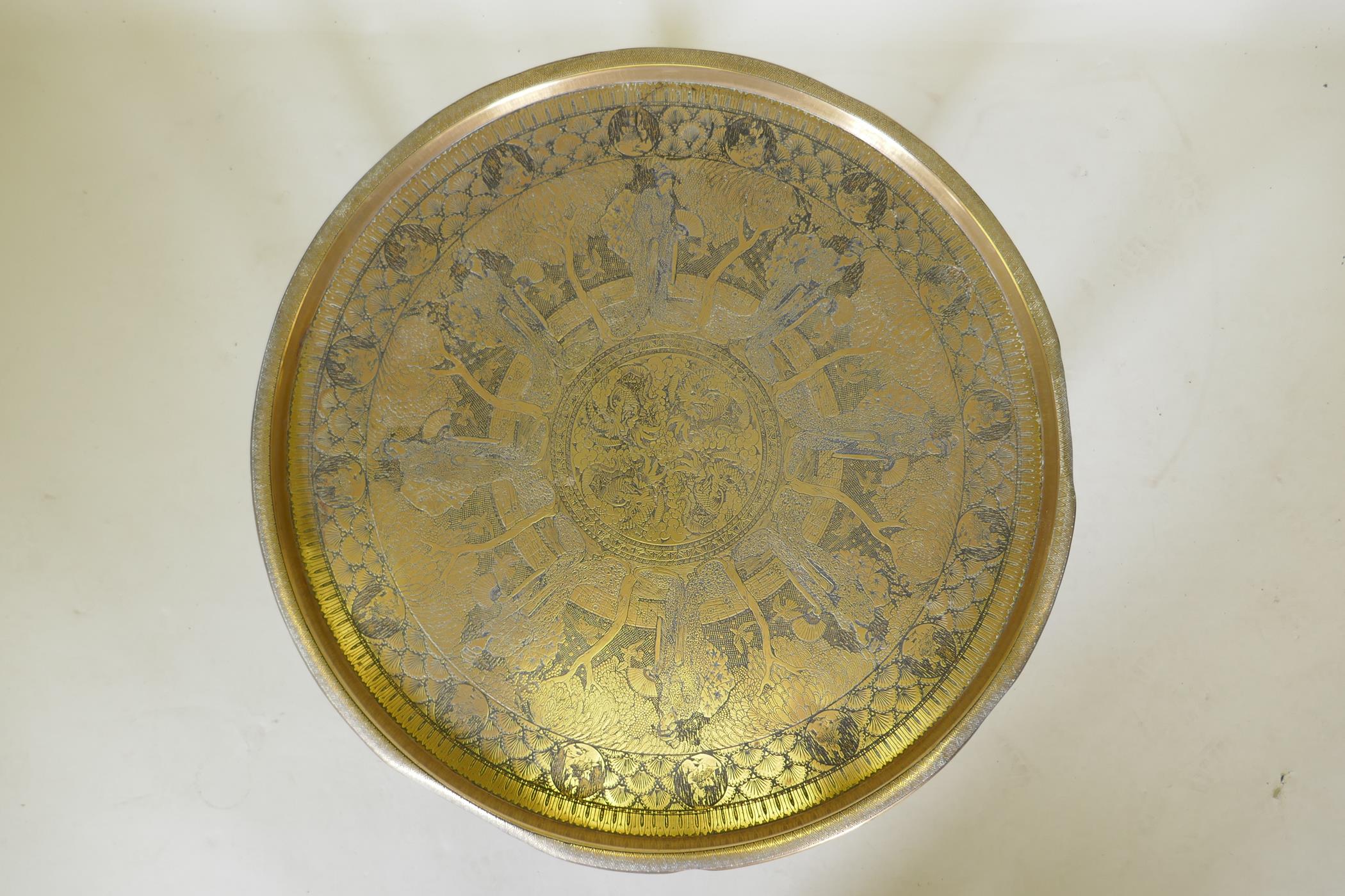 A Victorian brass top table with Japanese inspired decoration, on a folding wood base, 59 dia. x - Image 2 of 7
