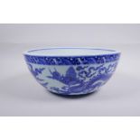 A blue and white porcelain bowl decorated with dragons in flight, Chinese Xuande 6 character mark to