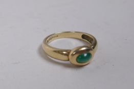 A 9ct gold ring set with a green crystal stone, size P, 3.1g gross