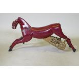 An antique painted wood and metal carousel horse, 75cm long, 36cm high