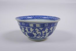 A Chinese blue and white porcelain rice bowl with script and lotus flower decoration, 13cm diameter