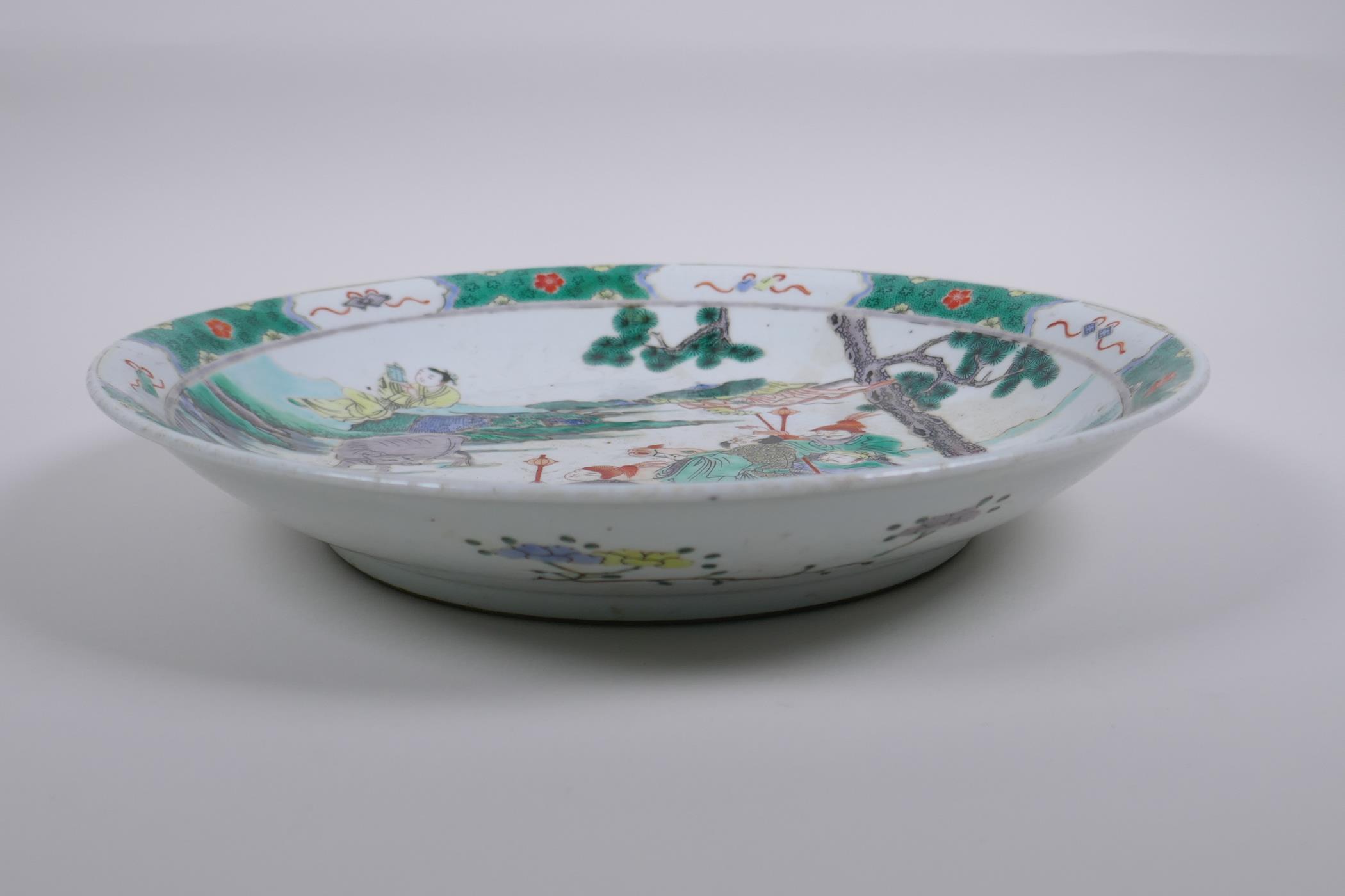 A Chinese KangXi style famille verte porcelain charger decorated with figures in a landscape, 29cm - Image 3 of 5