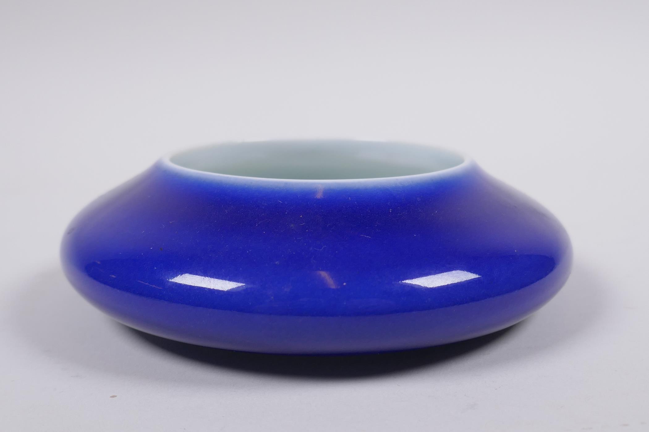 A Chinese powder blue glazed porcelain ink wash of shallow form, 13cm diameter