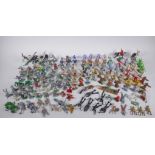 A large quantity of vintage plastic and metal toy soldiers depicting various eras, including