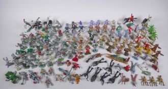 A large quantity of vintage plastic and metal toy soldiers depicting various eras, including