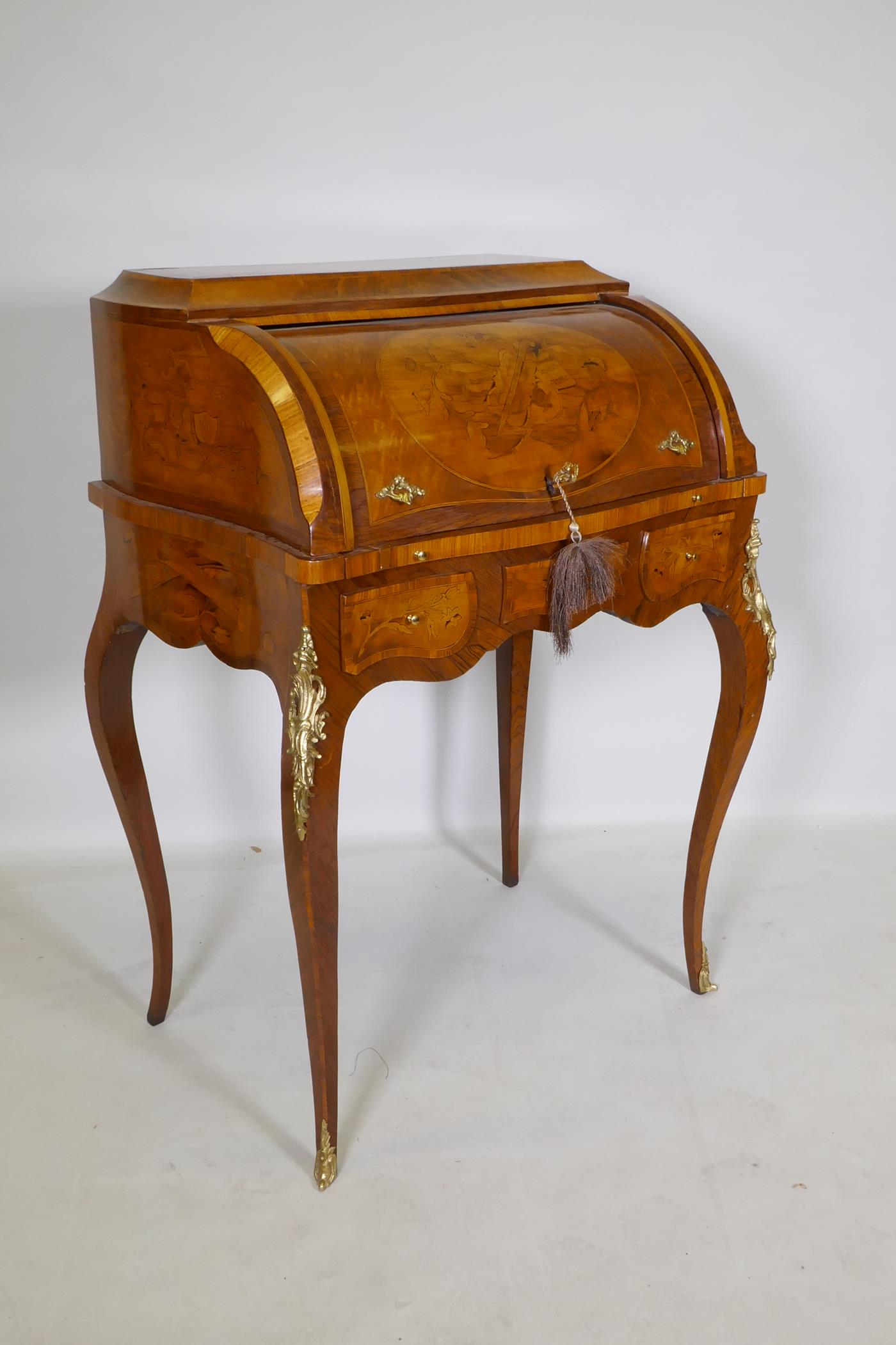 A rosewood marquetry inlaid bureau, with shaped top and cylinder front, the interior fitted with