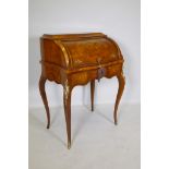 A rosewood marquetry inlaid bureau, with shaped top and cylinder front, the interior fitted with