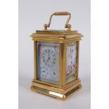 An ormolu and Sevres style porcelain carriage clock with day and date subsidiary dials, 8cm high