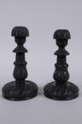 A pair of Anglo Indian carved ebony candlesticks, 14cm high