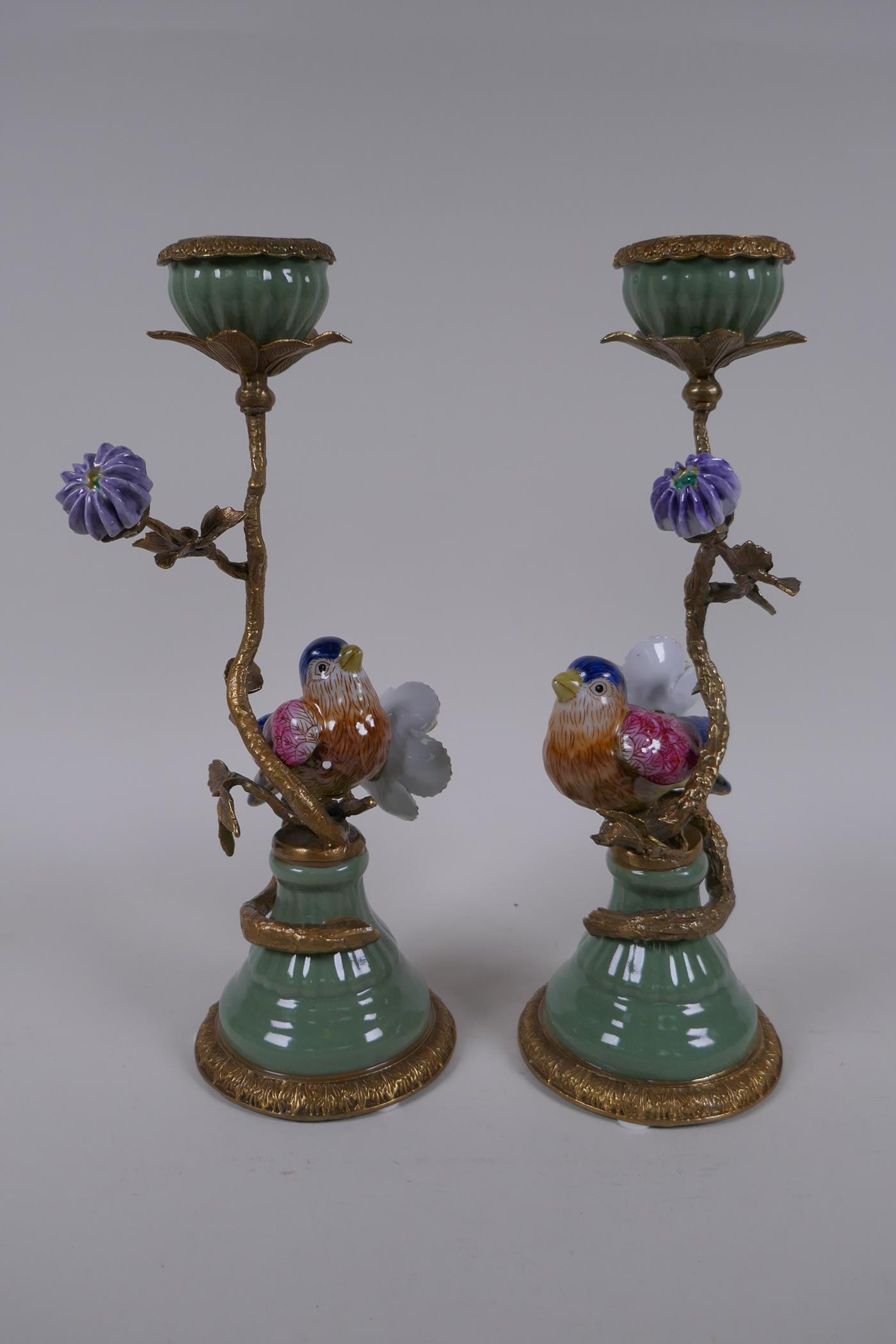 A pair of polychrome porcelain and gilt metal candlesticks decorated with birds and flowers, 29cm - Image 2 of 4