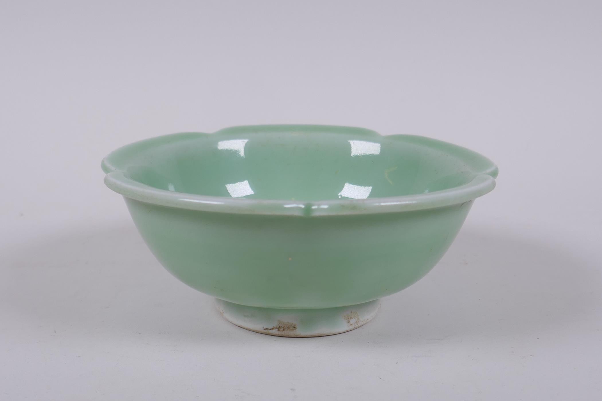 An oriental green glazed porcelain petal shaped bowl with underglaze prunus decoration, 14cm