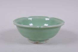 An oriental green glazed porcelain petal shaped bowl with underglaze prunus decoration, 14cm