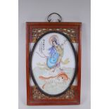 A Chinese republic style polychrome porcelain panel depicting Quan Yin standing on a carp, mounted