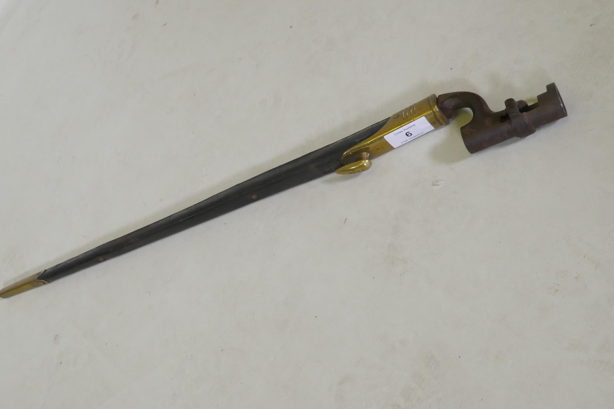 A British Army 1876 pattern socket bayonet in a leather scabbard with brass mounts, stamped WDE7 - Image 6 of 6