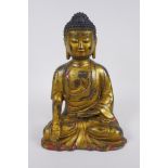 A Chinese gilt and painted bronze figure of Buddha, impressed 4 character mark to the reverse,