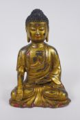 A Chinese gilt and painted bronze figure of Buddha, impressed 4 character mark to the reverse,