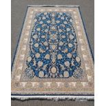 A fine woven blue and cream ground Persian carpet full pile with traditional allover floral