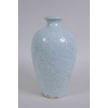 A Chinese celadon glazed porcelain vase with incised lotus flower decoration, 22cm high