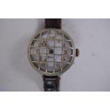 A WWI trench watch, with illuminated Arabic numerals on a shaped white dial with subsidiary second