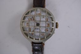 A WWI trench watch, with illuminated Arabic numerals on a shaped white dial with subsidiary second