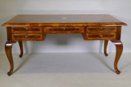 A continental walnut and marquetry inlaid bureau plat, with five drawers, raised on cabriole