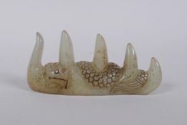 A Chinese jade brush rest with carved dragon decoration, 12cm long