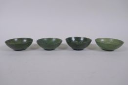 Four Chinese spinach jade bowls, AF repairs, 7cm diameter