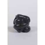 A Japanese carved boxwood netsuke in the form of a snake, 2cm