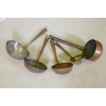 A collection of Middle Eastern copper cooking vessels, longest 58cm