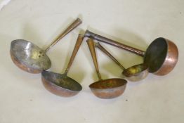 A collection of Middle Eastern copper cooking vessels, longest 58cm