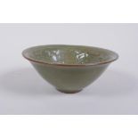 A Chinese Yaozhou kiln olive glazed bowl decorated with a floral design, 10cm diameter