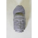 An oriental carved basalt Buddha head, 41cm high