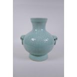 A Chinese celadon glazed porcelain vase with two loop handles and patterned underglaze decoration,