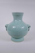 A Chinese celadon glazed porcelain vase with two loop handles and patterned underglaze decoration,