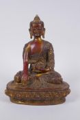 A Sino Tibetan gilt and coppered bronze figure of Buddha, 23cm high
