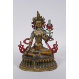 A Sino Tibetan cold painted metal figure of a female deity, 21cm high