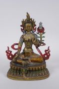 A Sino Tibetan cold painted metal figure of a female deity, 21cm high