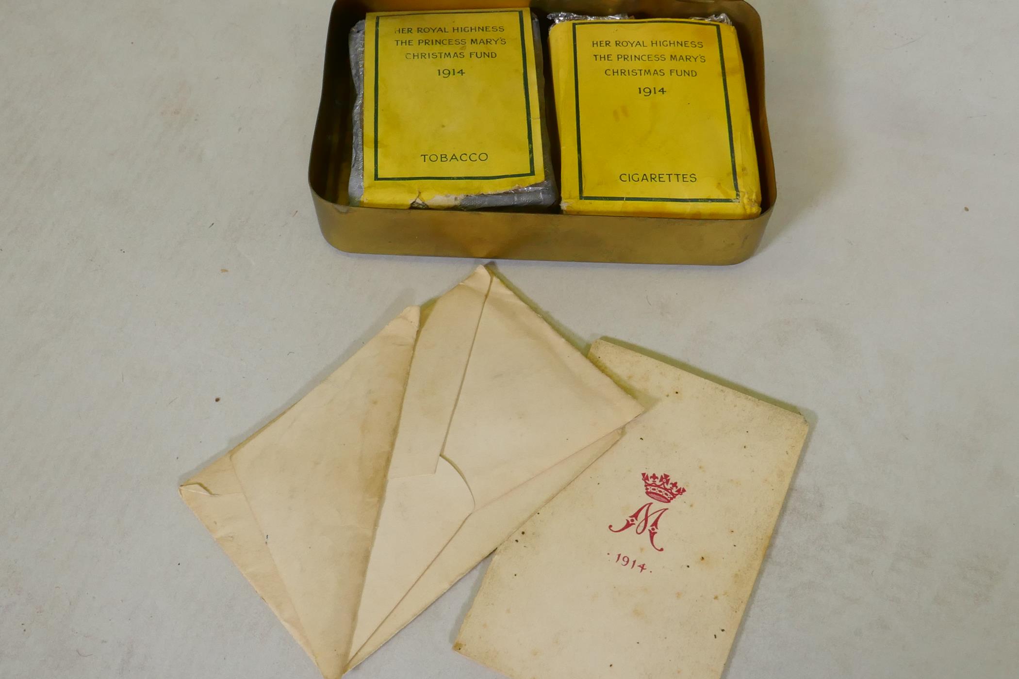 A WWI Christmas 1914 Princess Mary gift tin, with cigarettes and unopened tobacco, and greetings - Image 2 of 3