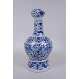 An C18th/C19th Delft blue and white garlic head shaped vase, decorated with birds, flowers and