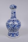 An C18th/C19th Delft blue and white garlic head shaped vase, decorated with birds, flowers and