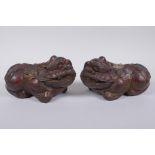 A pair of Chinese filled bronze kylin, with the remnants of gilt and copper patina, impressed 4