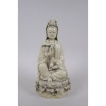 A Chinese blanc de chine porcelain Quan Yin seted on a lotus flower, impressed mark verso, 26cm high