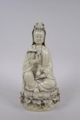 A Chinese blanc de chine porcelain Quan Yin seted on a lotus flower, impressed mark verso, 26cm high