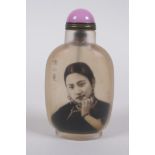 A Chinese reverse decorated glass snuff bottle decorated with a female figure, character inscription