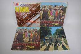 Four original Beatles vinyl albums including two first pressings of Sgt Pepper's Lonely Hearts