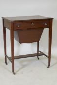 A C19th mahogany work table, the single drawer with fitted interior and pull out basket under,